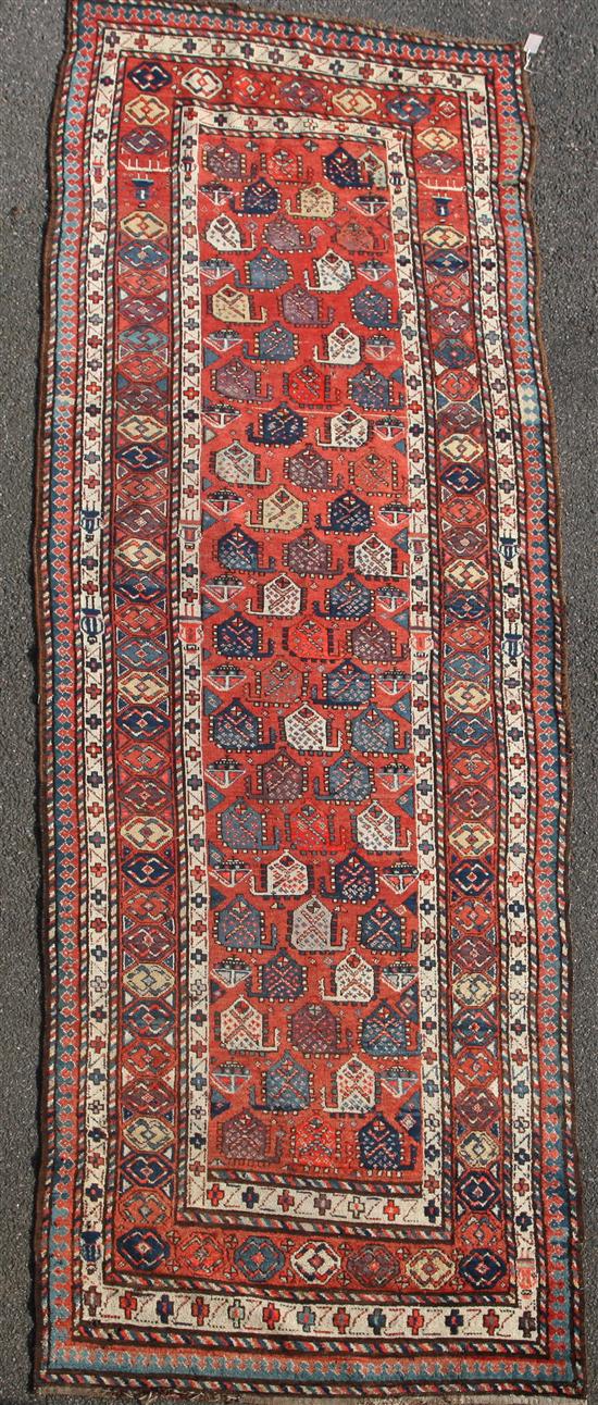 A Gendje red ground runner, c.1900, 13ft 4in by 4ft.